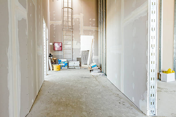 View through corridor of gypsum, plasterboard walls under construction.